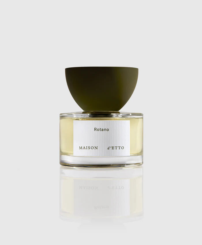 A bottle of Rotano Eau de Parfum by Maison d'Etto with a clear liquid visible inside, a white label, and a green cap.
