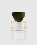 A bottle of Noisette Eau de Parfum by Maison d'Etto with a clear glass and a green cap, displaying the label and the perfume inside.