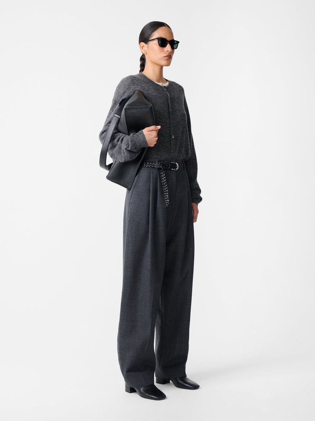 Side view of model in Studio Nicholson Acuna Wool Pant, highlighting elongated wide-leg cut and relaxed drape in slate melange wool.