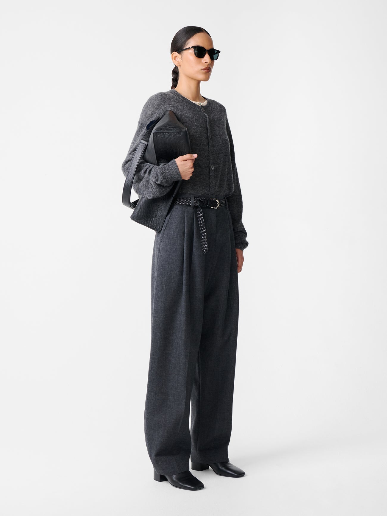 Side view of model in Studio Nicholson Acuna Wool Pant, highlighting elongated wide-leg cut and relaxed drape in slate melange wool.