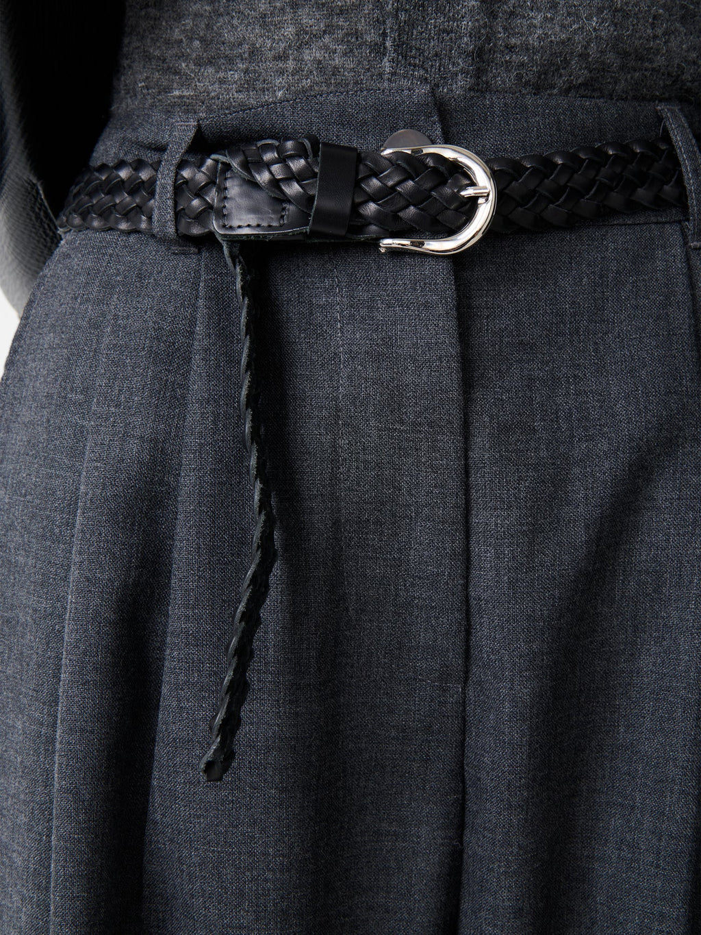 Close-up of Studio Nicholson Acuna Wool Pant waistband with belt loop detail, showing fine tailoring and wool fabric texture.