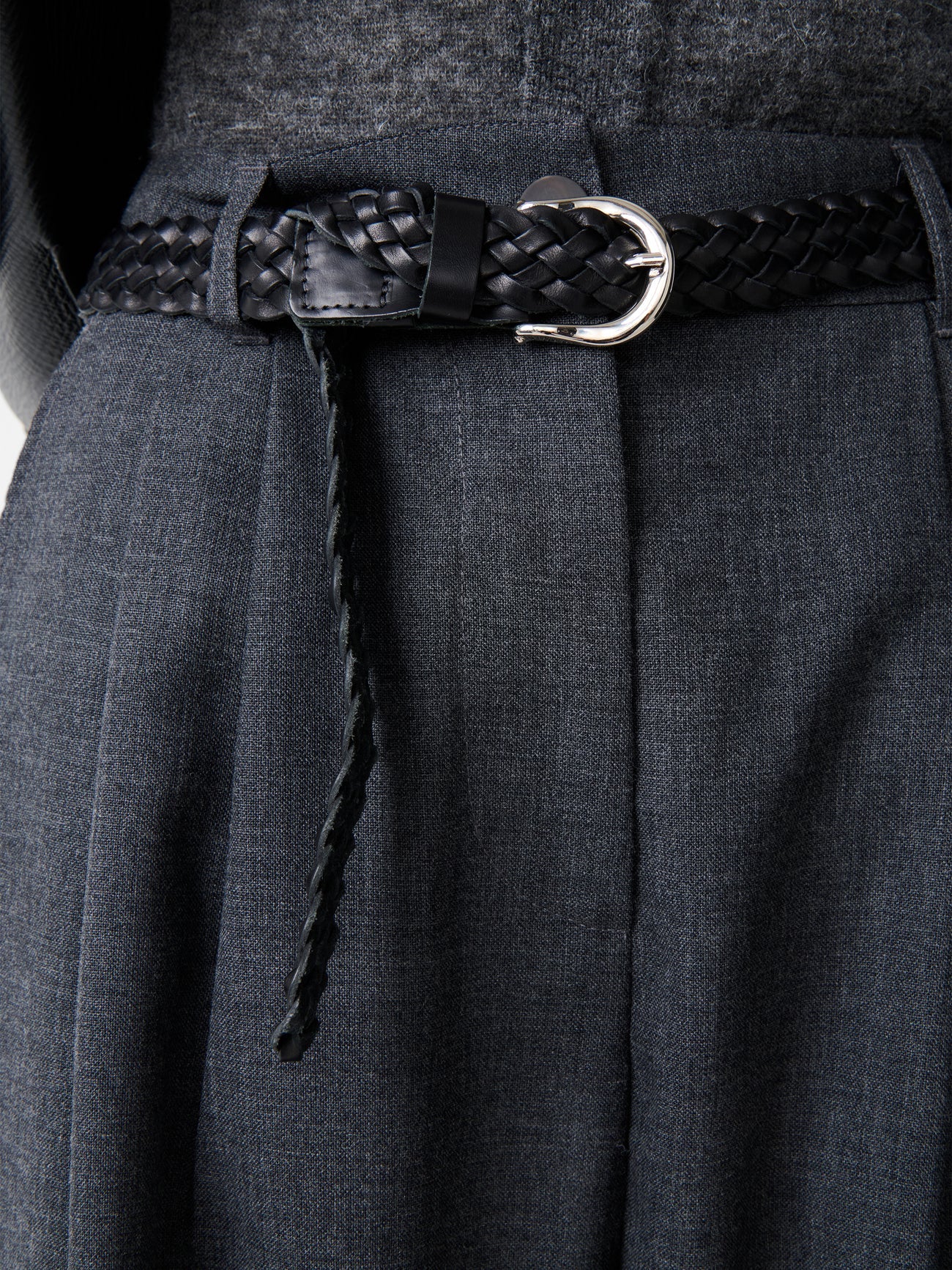 Close-up of Studio Nicholson Acuna Wool Pant waistband with belt loop detail, showing fine tailoring and wool fabric texture.