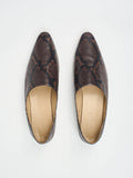 A pair of burgundy cobra patterned mules by Jamie Haller, viewed from the top, showing the pointed toe and flat sole.