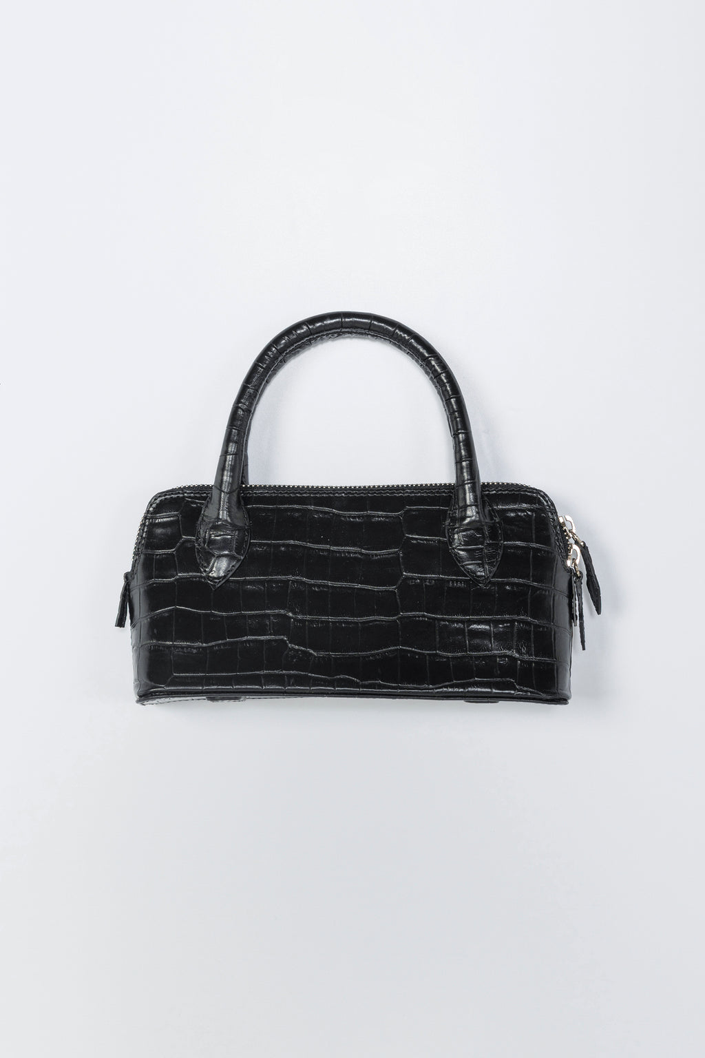 Black crocodile-patterned handbag on a light gray background