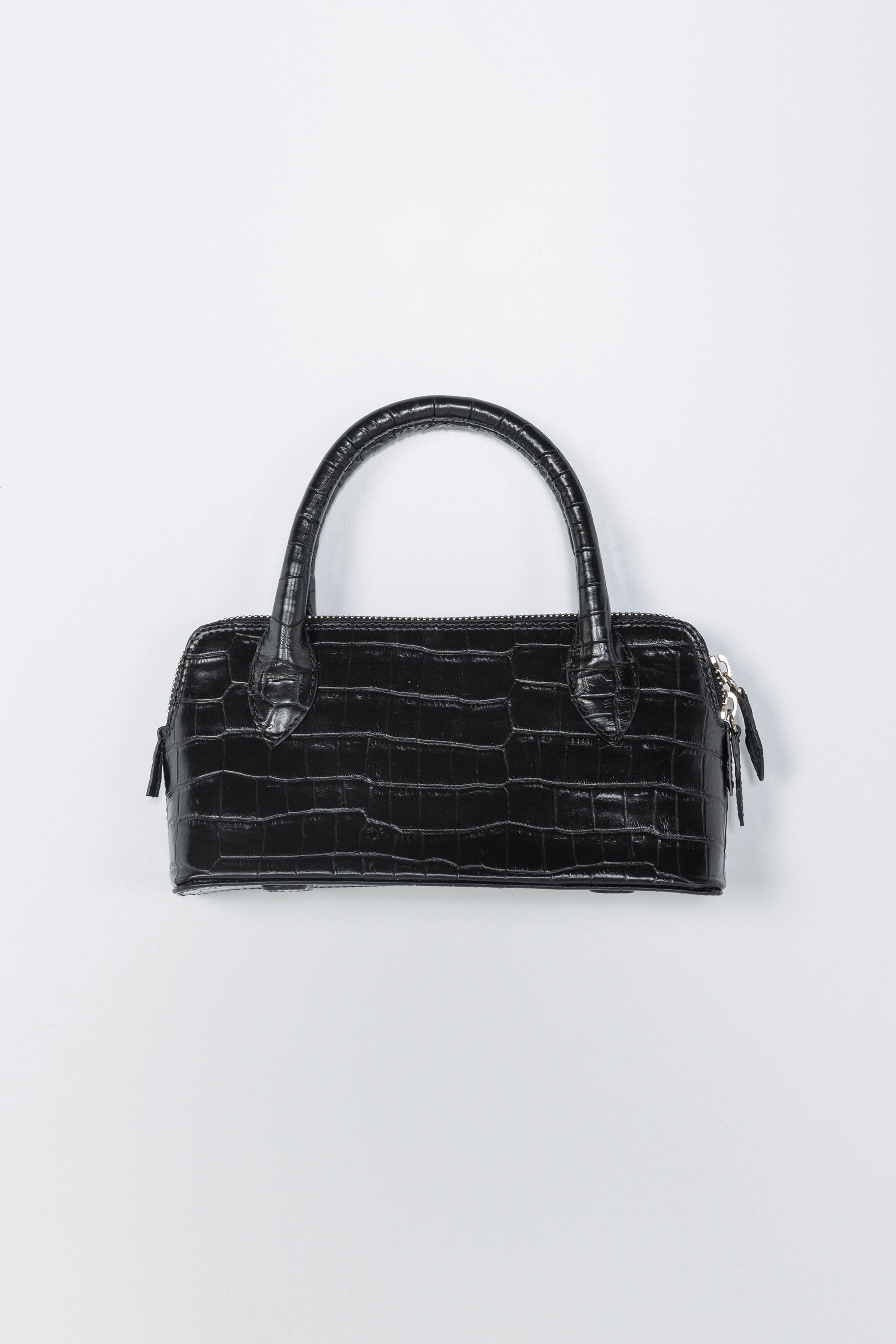 Black crocodile-patterned handbag on a light gray background