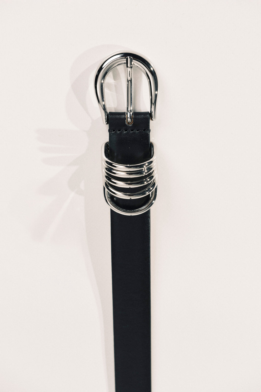 Black belt with silver buckle on a white background