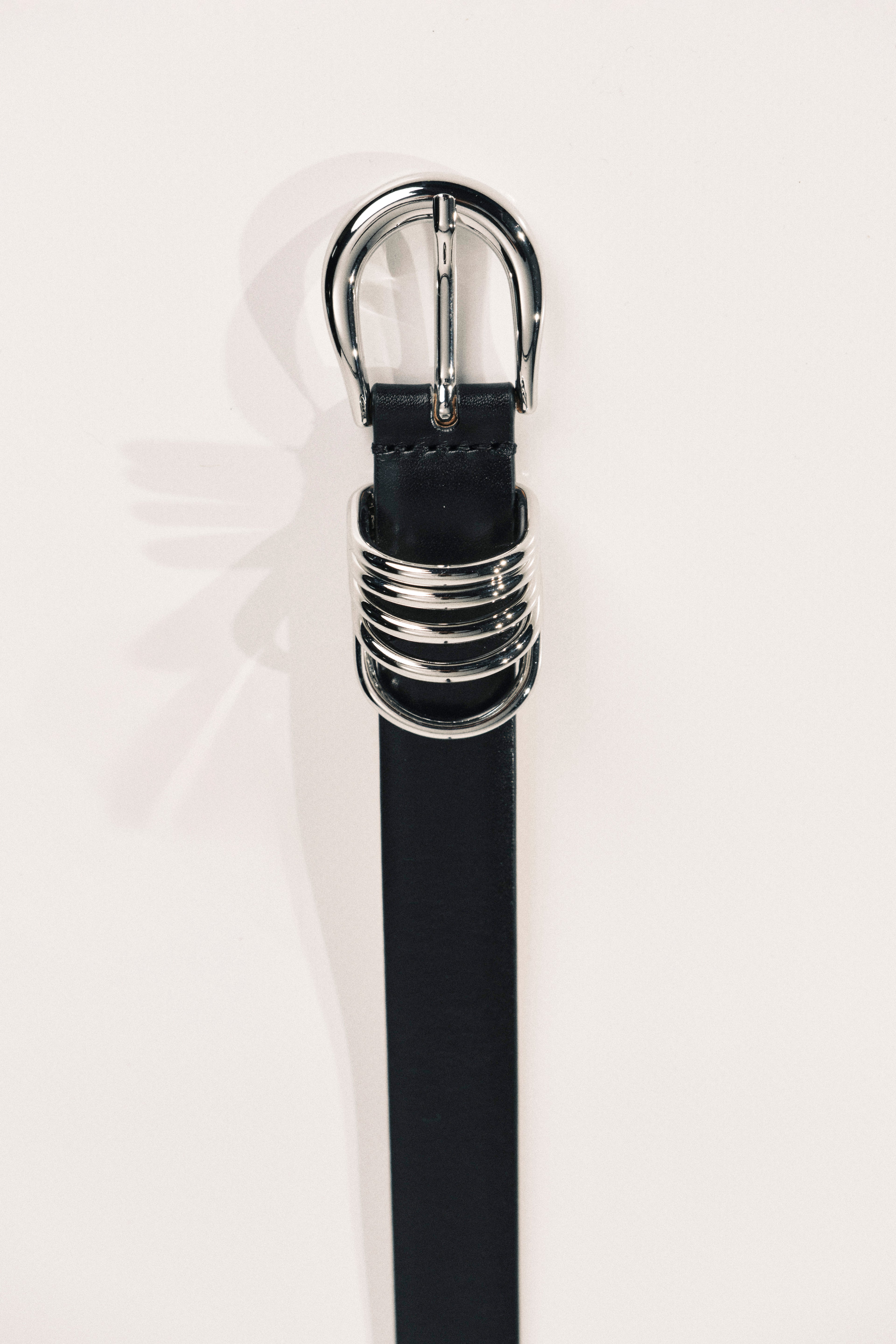 Black belt with silver buckle on a white background
