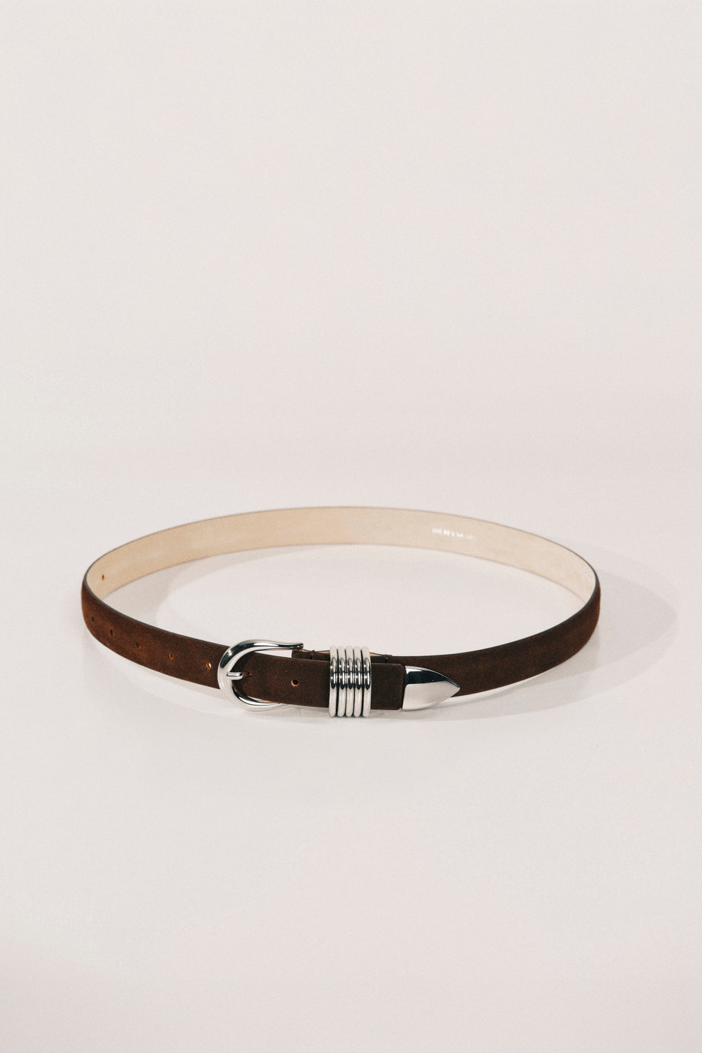 Belt with a decorative buckle on a light gray background