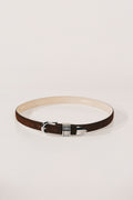 Belt with a decorative buckle on a light gray background