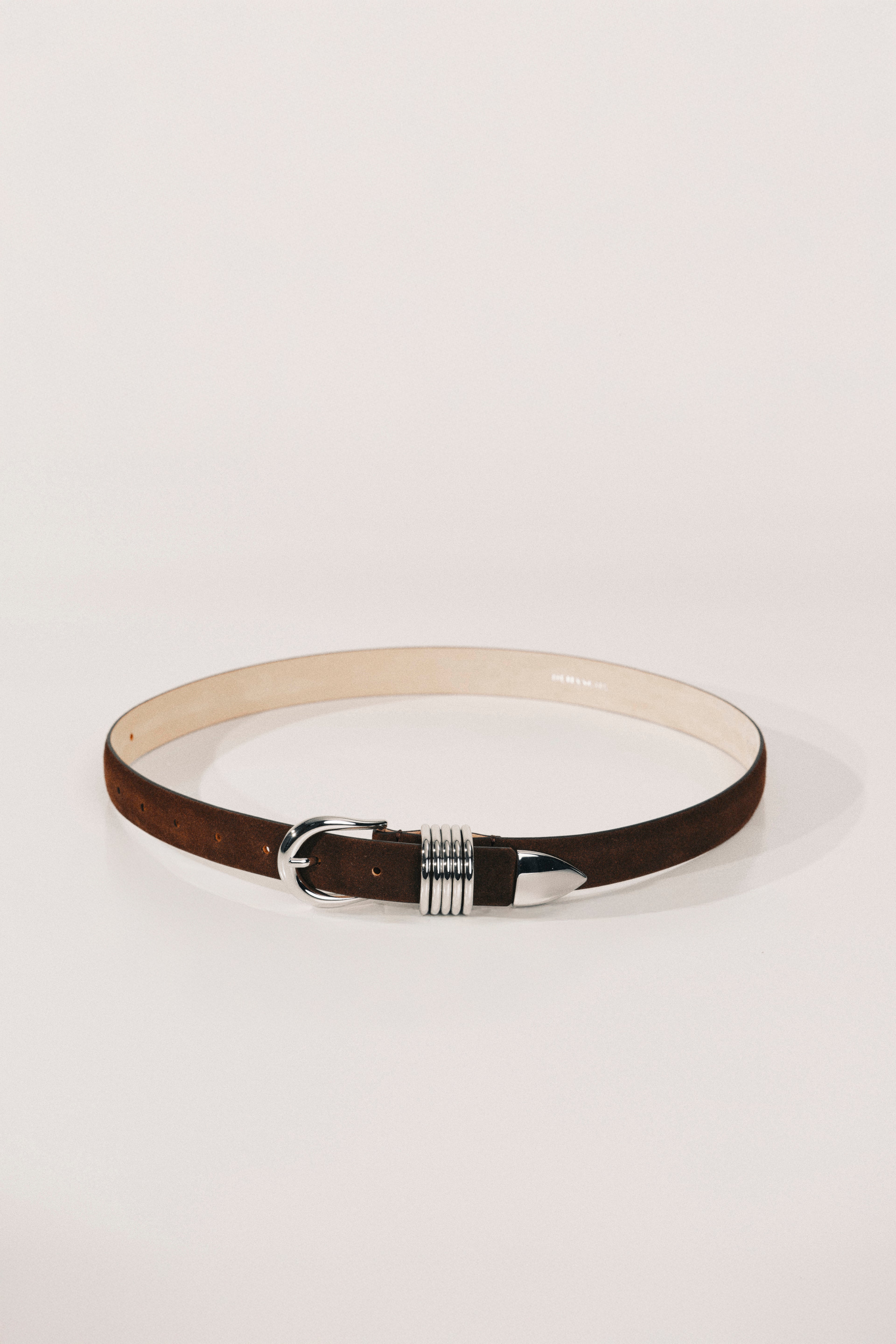Belt with a decorative buckle on a light gray background