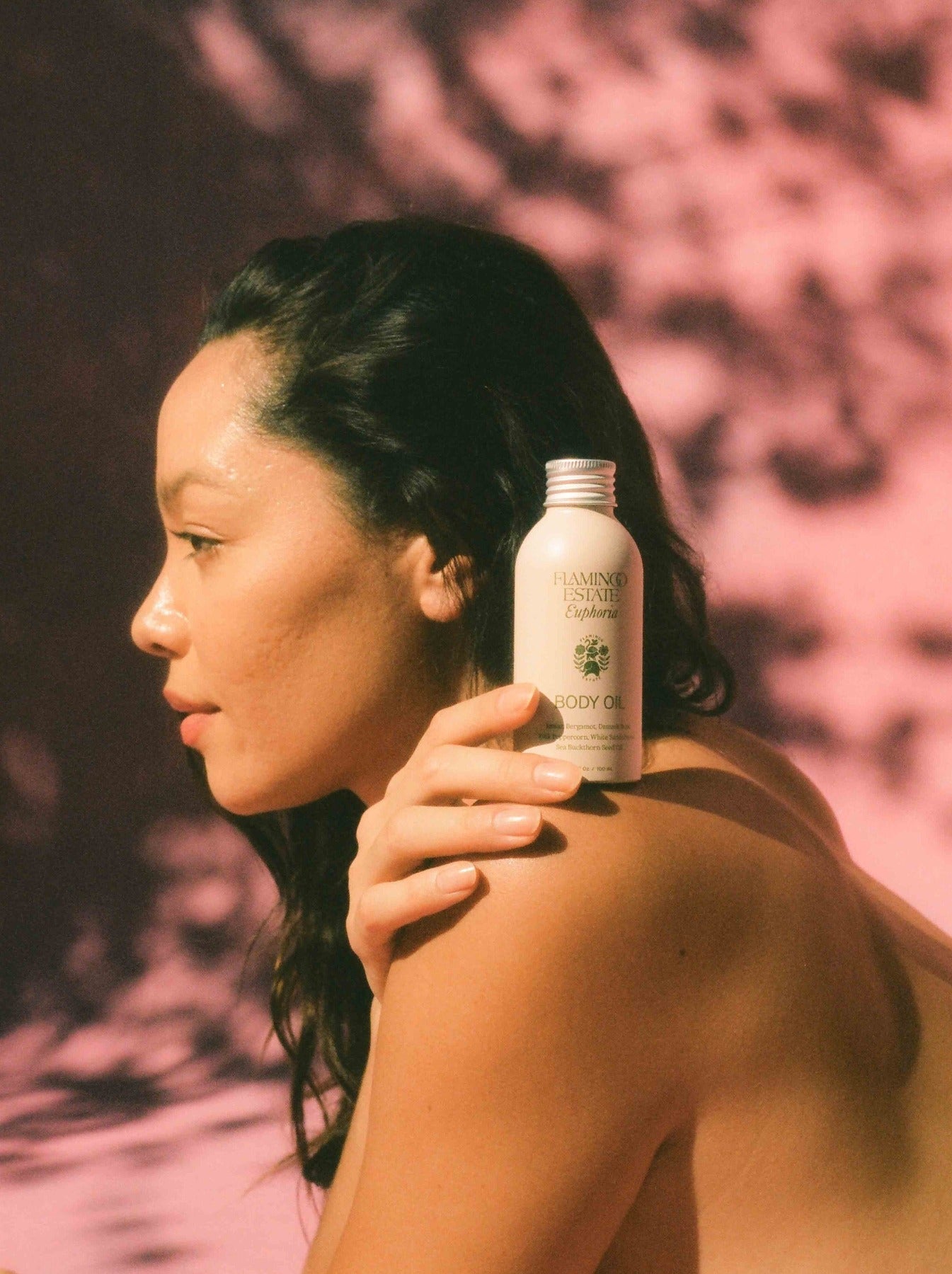 Person applying body oil with a blurred background