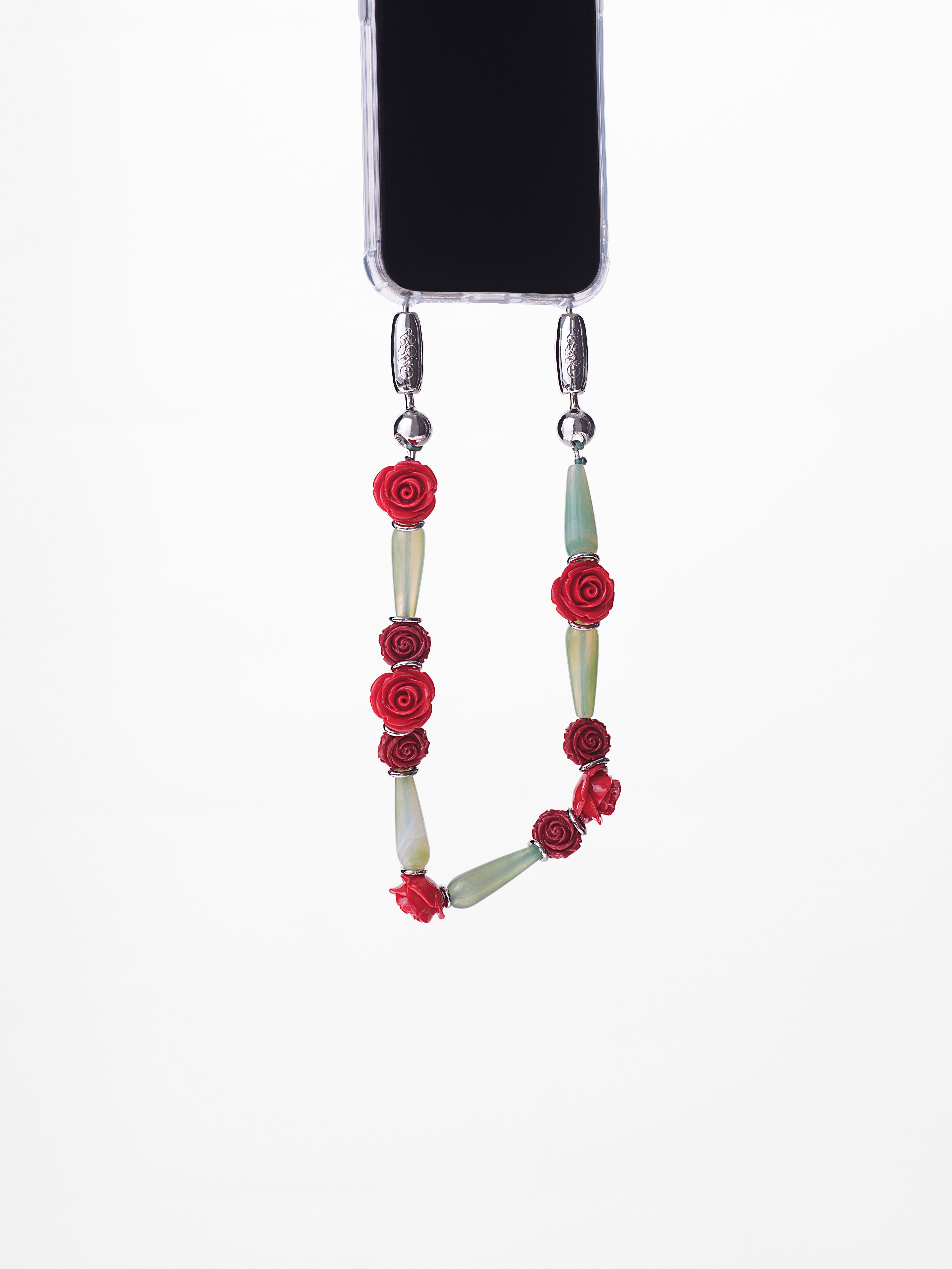Phone lanyard with floral design attached to a phone on a white background