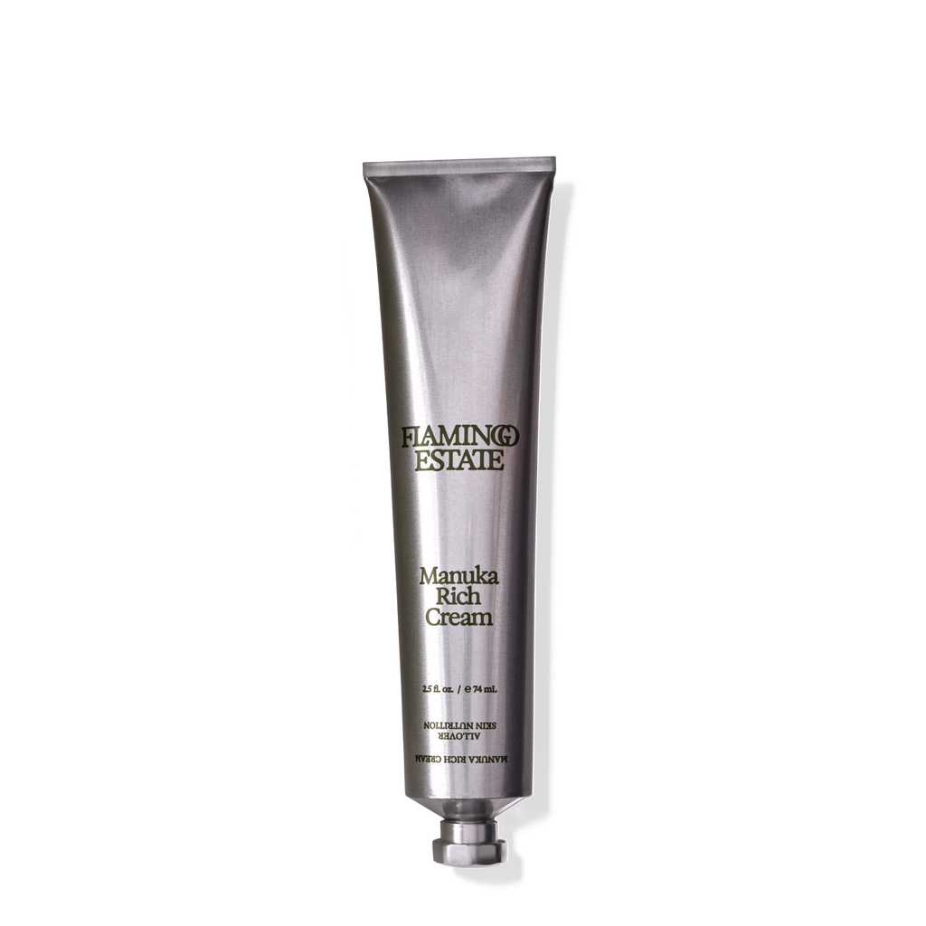 A tube of Manuka Rich Cream by Flamingo Estate with a silver and black design, indicating it is a body cream product.