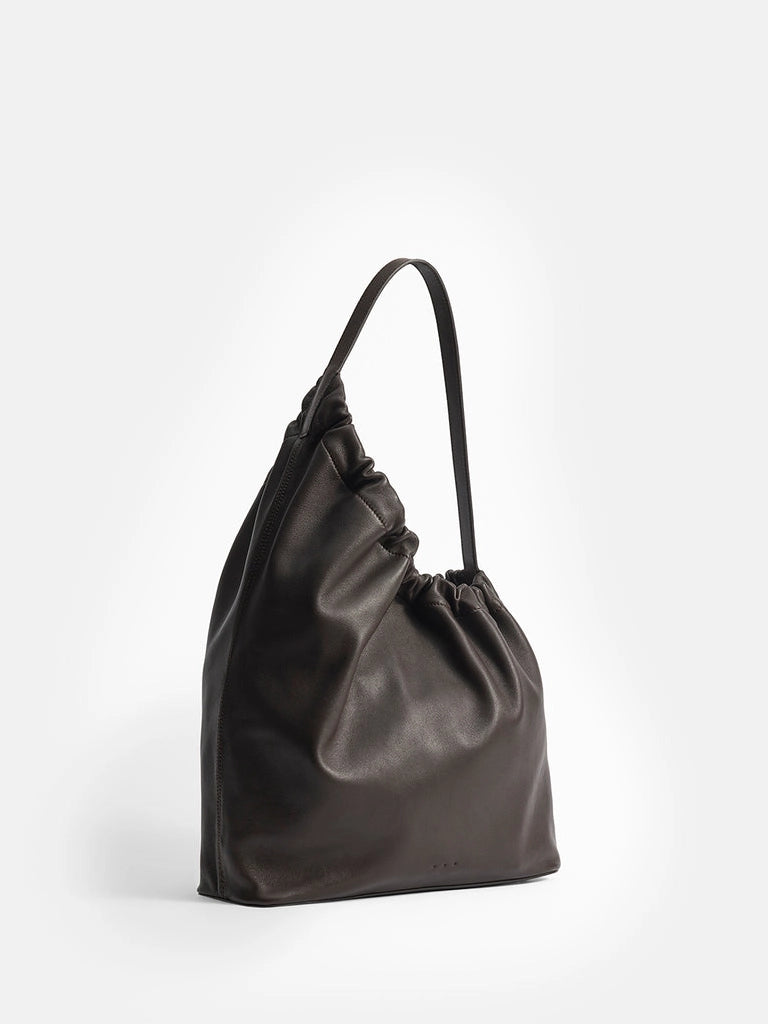 Aesther Ekme Demi Lune Cloud in tabacco calfskin with an asymmetrical shape, ruched opening and long shoulder strap.