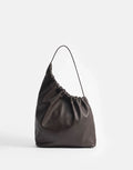 Aesther Ekme Demi Lune Cloud in tabacco calfskin with an asymmetrical shape, ruched opening and long shoulder strap.