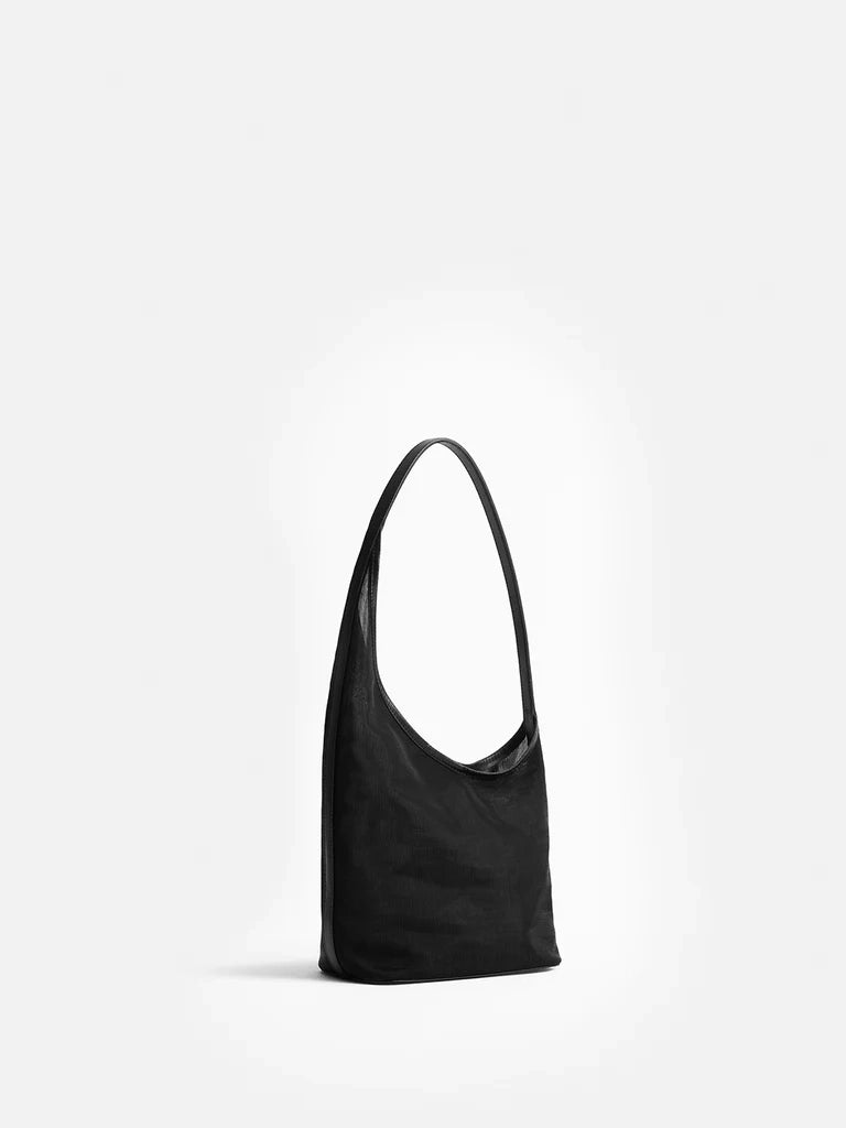 Black shoulder bag on a light gray background
