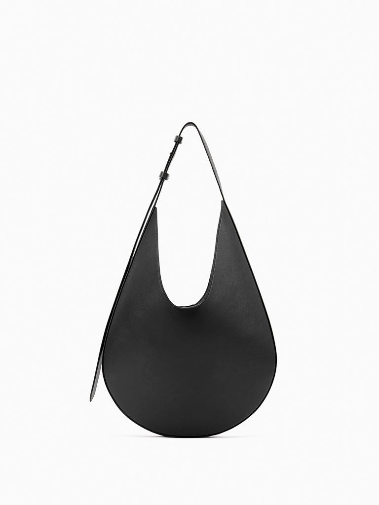 Aesther Ekme Hobo in black smooth calfskin with a sculptural curved silhouette and adjustable shoulder strap.