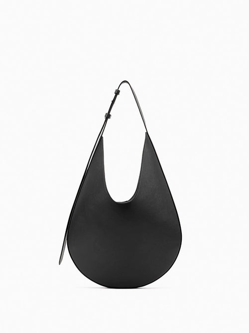 Aesther Ekme Hobo in black smooth calfskin with a sculptural curved silhouette and adjustable shoulder strap.