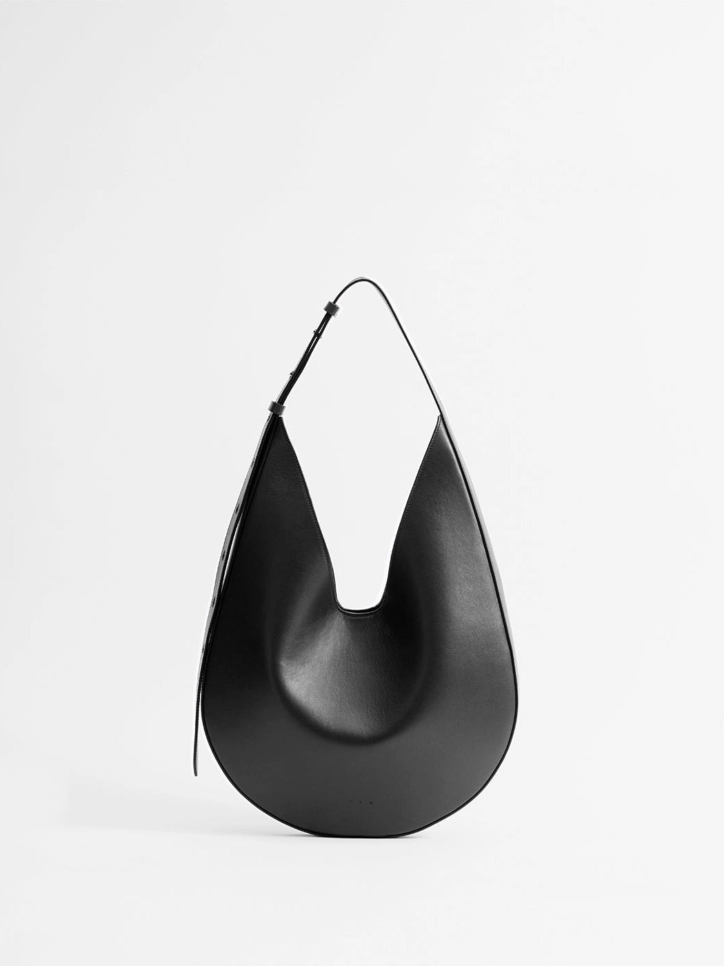 Aesther Ekme Hobo in black smooth calfskin with a sculptural curved silhouette and adjustable shoulder strap.