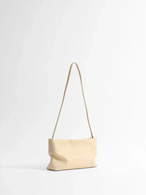 Beige handbag with a strap on a white background