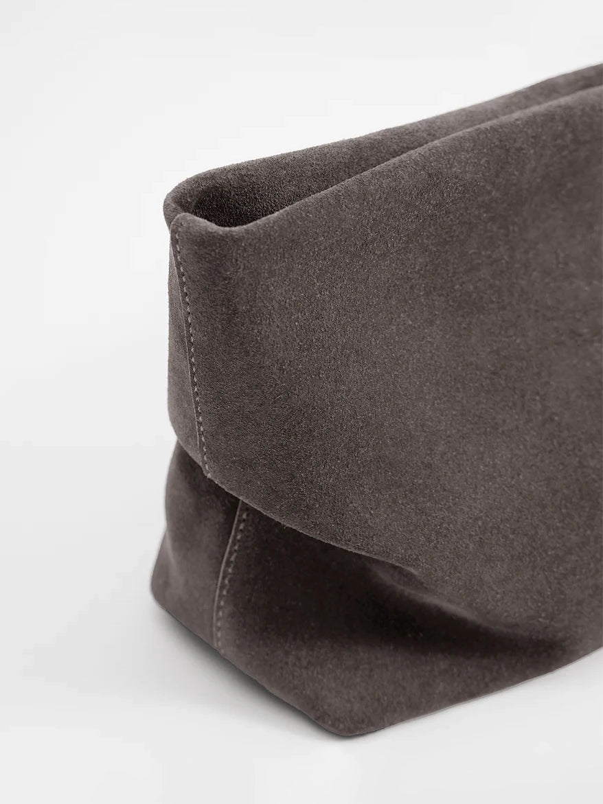 Aesther Ekme Nina Clutch in dark suede taupe with a draped, softly structured silhouette and detachable strap.