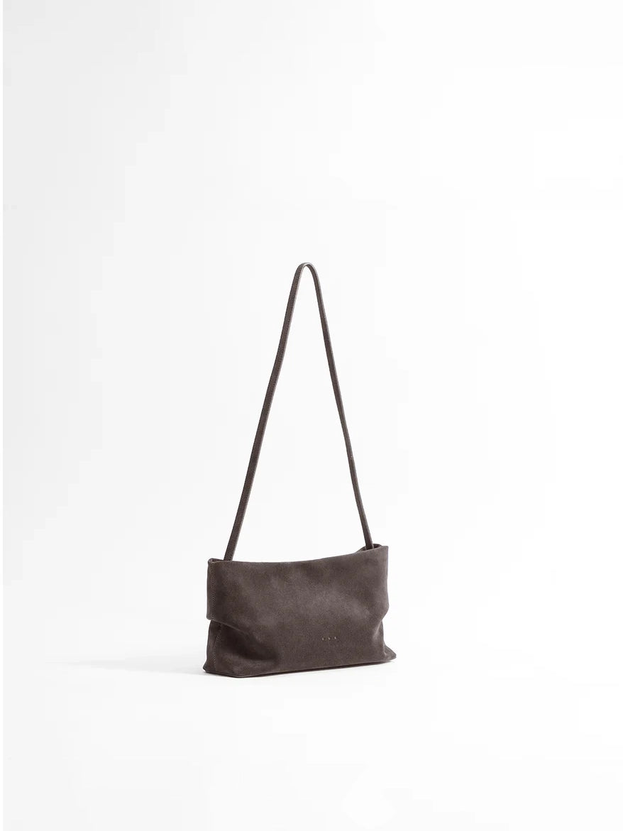 Aesther Ekme Nina Clutch in dark suede taupe with a draped, softly structured silhouette and detachable strap.
