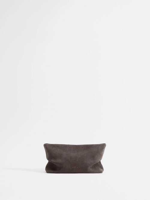 Aesther Ekme Nina Clutch in dark suede taupe with a draped, softly structured silhouette and detachable strap.