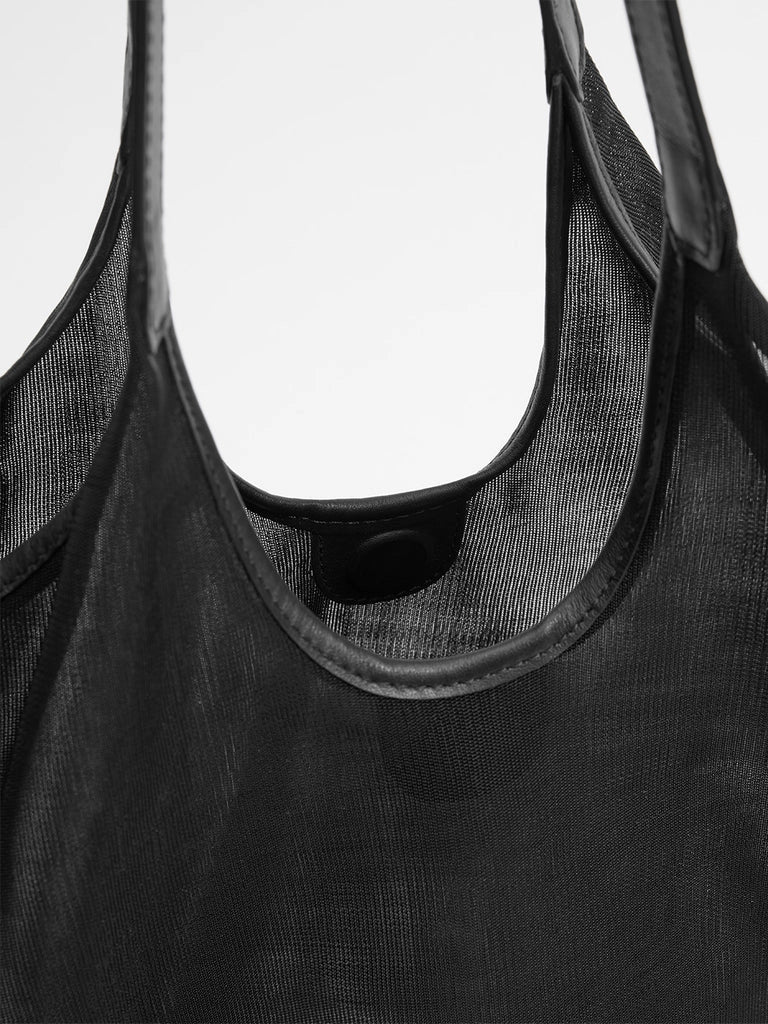 Black mesh bag with straps on a white background