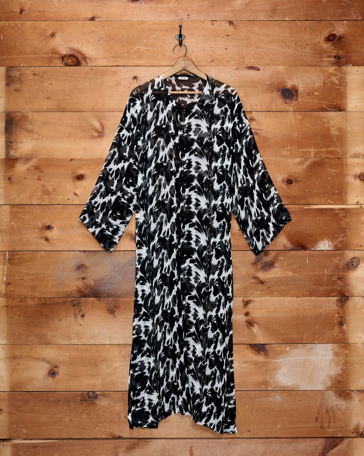 Bode Appaloosa Kaftan in black and white textured silk crepe with an all-over spotted print and black frog closures.