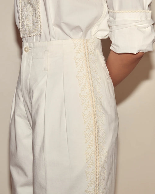 White shirt with lace detailing on a plain background