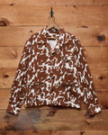 Bode Flannel Cow Print Long Sleeve Shirt in brown and white cotton flannel with a boxy fit and three patch pockets.