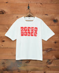 Bode Rodeo Bodeo Tee in white with a red flocked graphic across the chest.