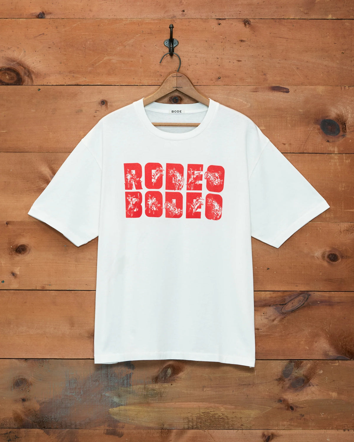 Bode Rodeo Bodeo Tee in white with a red flocked graphic across the chest.