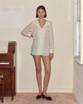Model wearing white Bode cotton voile shirt with a sailor collar, chest patch pocket and antique pearl buttons.
