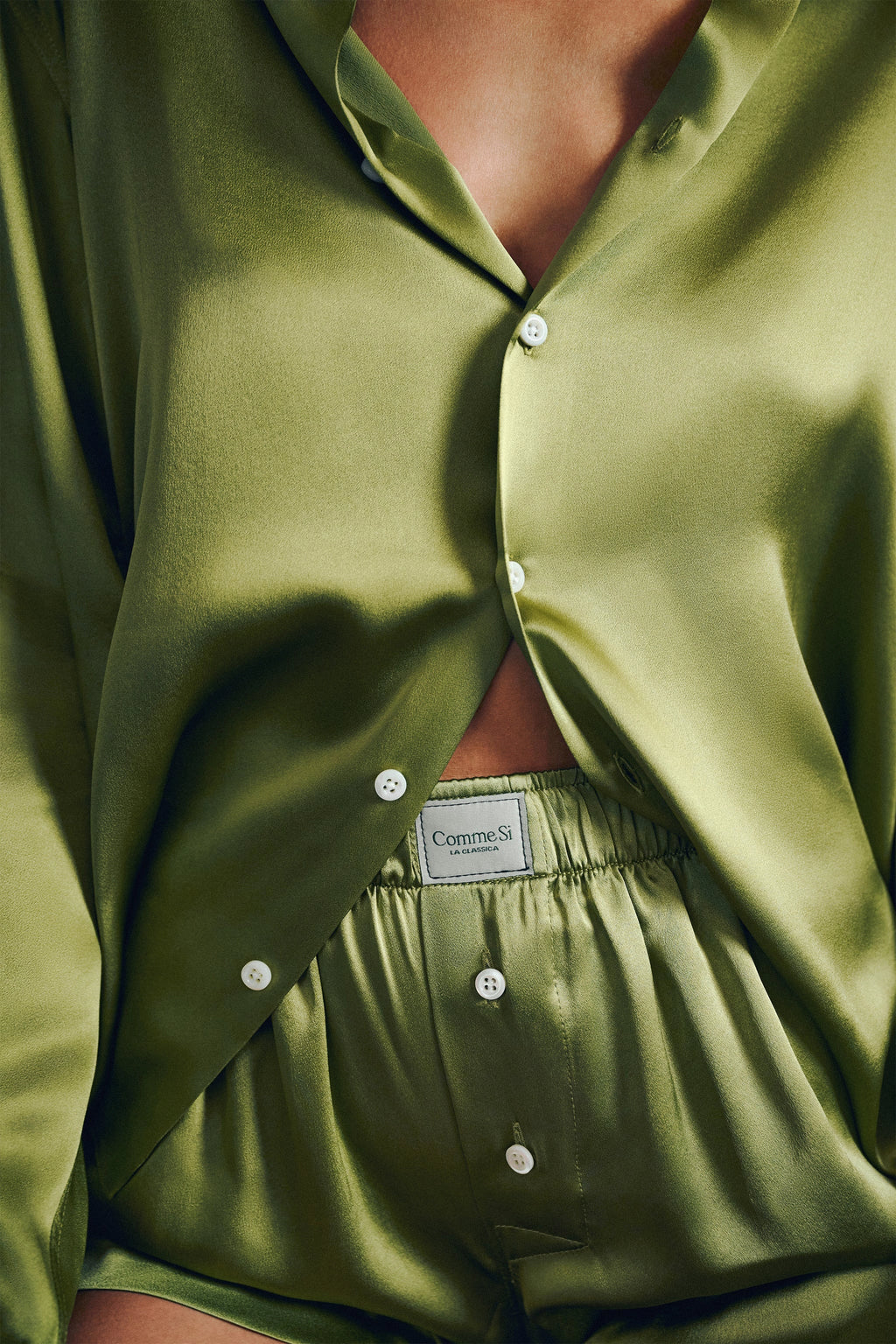 Green satin pajama set with a brand label on the waistband.