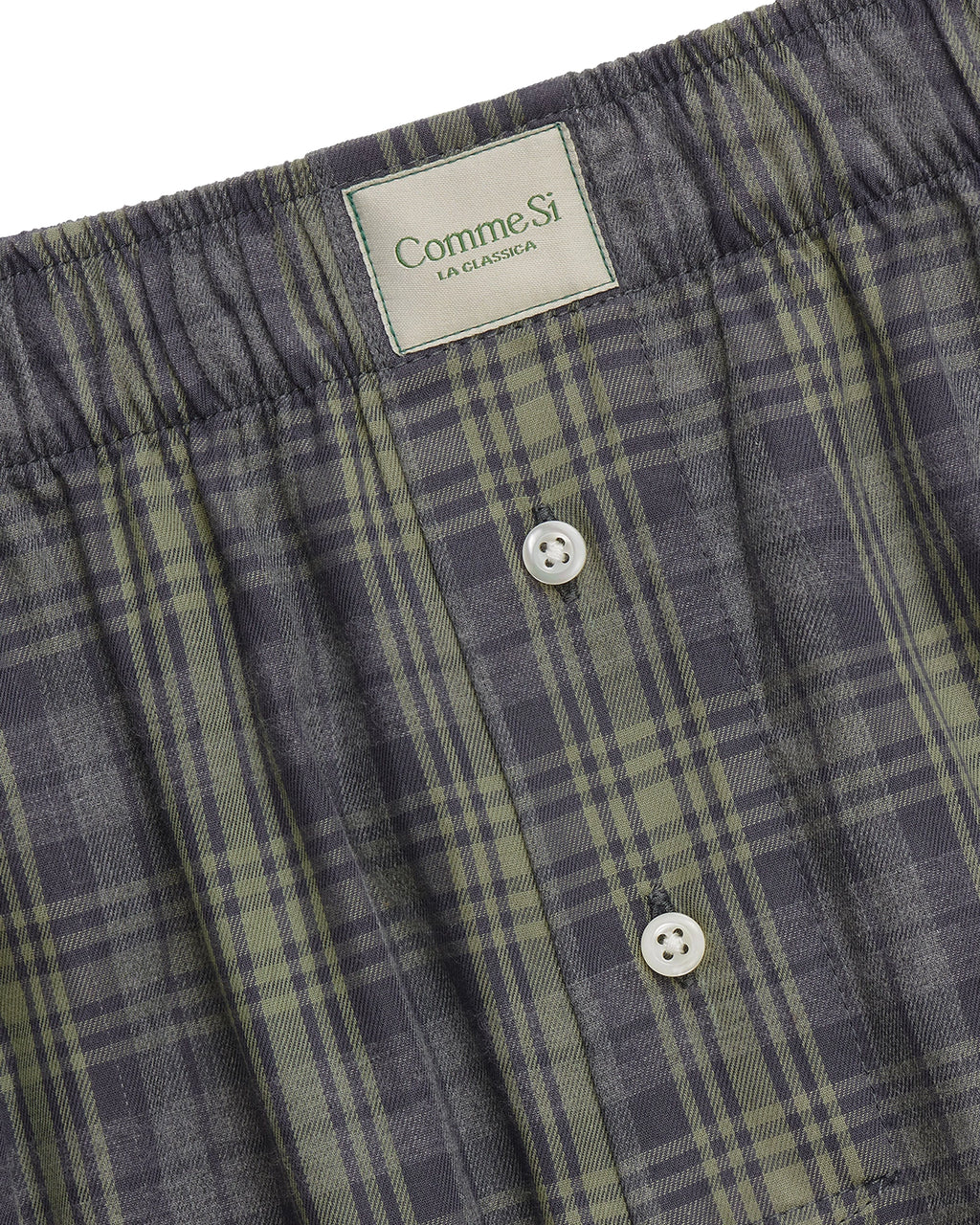 Comme Si La Boxer Alta in grey sage plaid cotton flannel with a wide-leg silhouette, covered elastic waistband, and side slits at the hem.