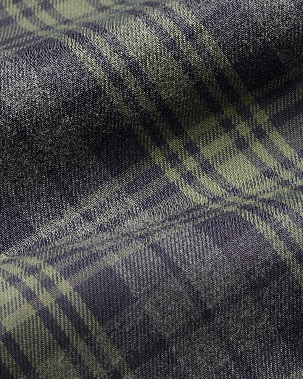Fabric detail of Comme Si La Boxer Alta in grey sage plaid cotton flannel with a wide-leg silhouette, covered elastic waistband, and side slits at the hem.
