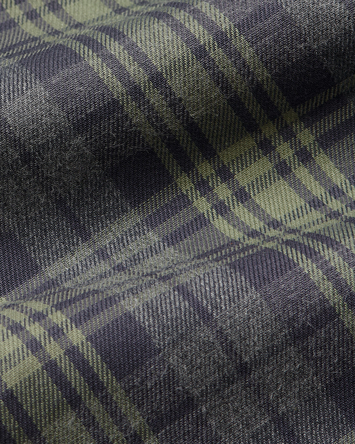 Fabric detail of Comme Si La Boxer Alta in grey sage plaid cotton flannel with a wide-leg silhouette, covered elastic waistband, and side slits at the hem.
