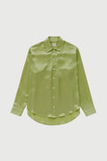 Green satin shirt on a light gray background