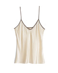 Comme Si Silk Bias Cami in cream silk charmeuse with contrasting brown piping, a V neckline, and thin adjustable straps.