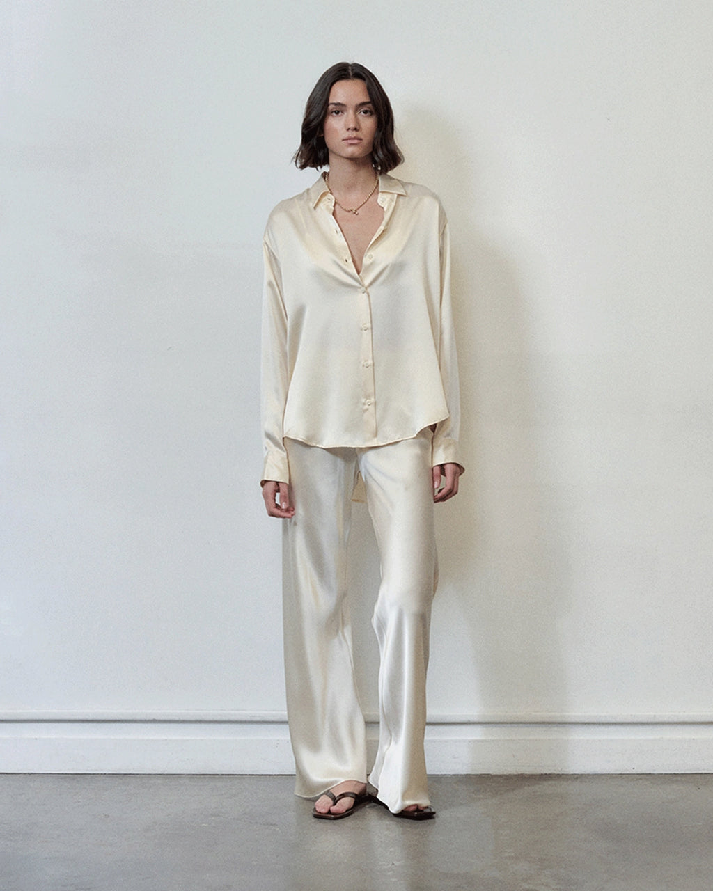 Model wearing Comme Si Silk Bias Pant in cream silk charmeuse with a fluid drape and elongated silhouette.