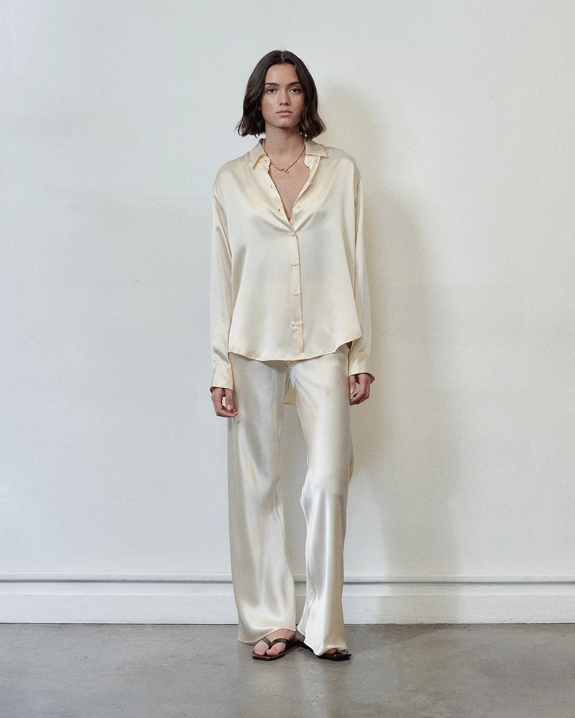 Model wearing Comme Si Silk Bias Pant in cream silk charmeuse with a fluid drape and elongated silhouette.
