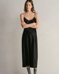 Model wearing Comme Si Silk Bias Slip Dress in Black
