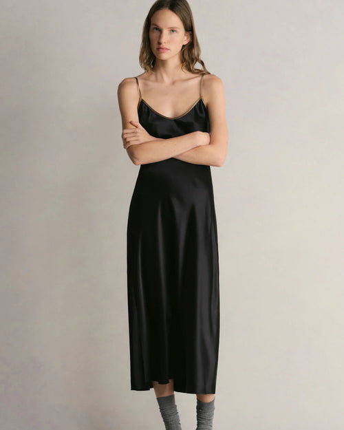 Model wearing Comme Si Silk Bias Slip Dress in Black