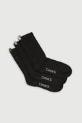 Black socks with 'Comme Si' branding on a light gray background