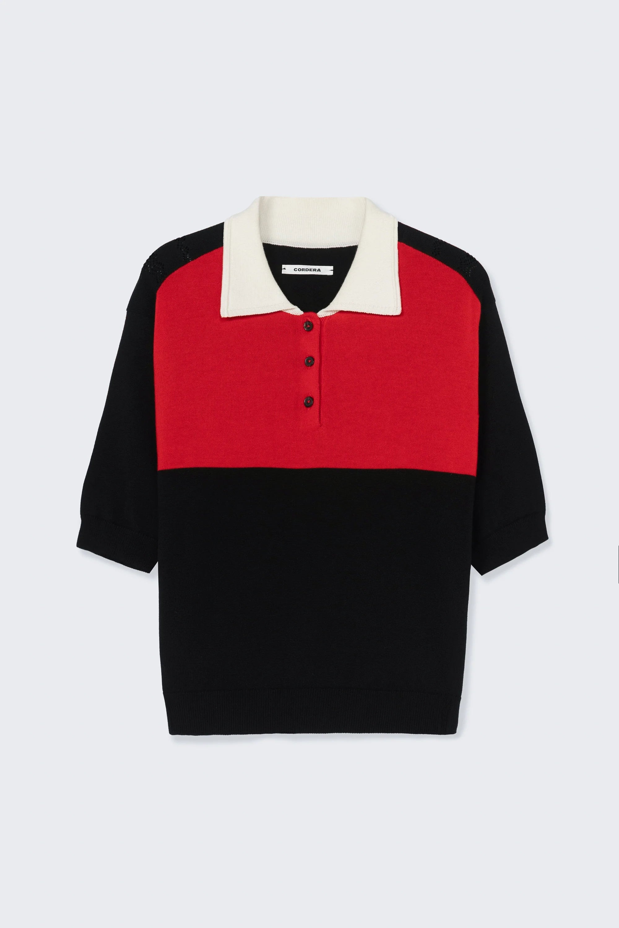 Color-blocked shirt with red, black, and white sections on a light gray background