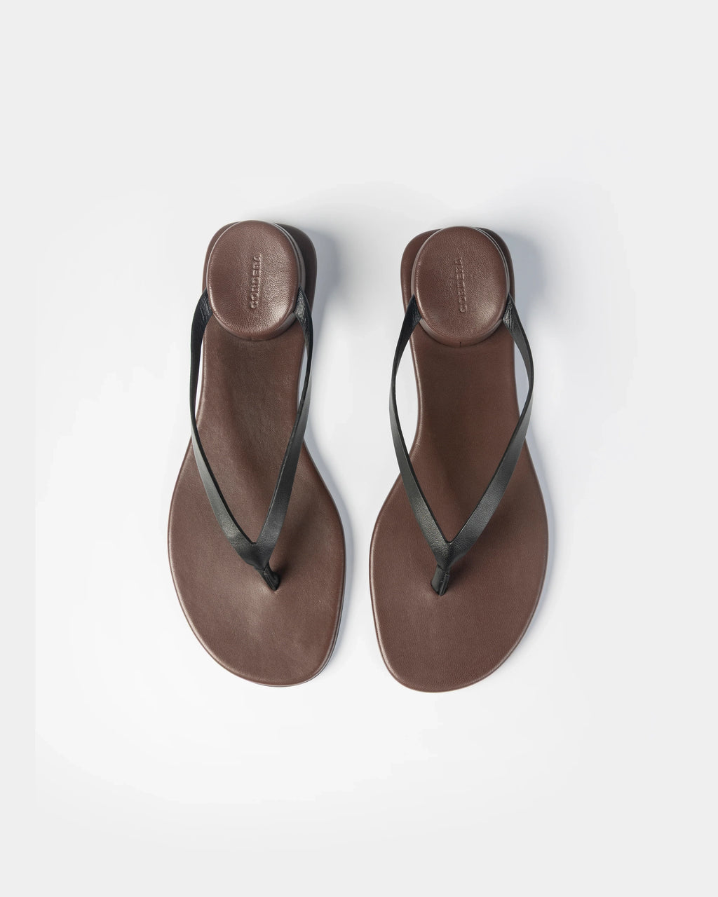 CORDERA Estructura Sandal in black calfskin with slim black straps, brown-burgundy sole and raised oval heel.