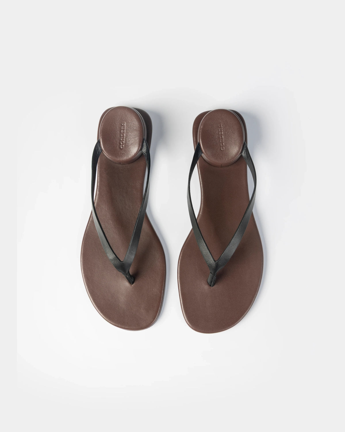 CORDERA Estructura Sandal in black calfskin with slim black straps, brown-burgundy sole and raised oval heel.