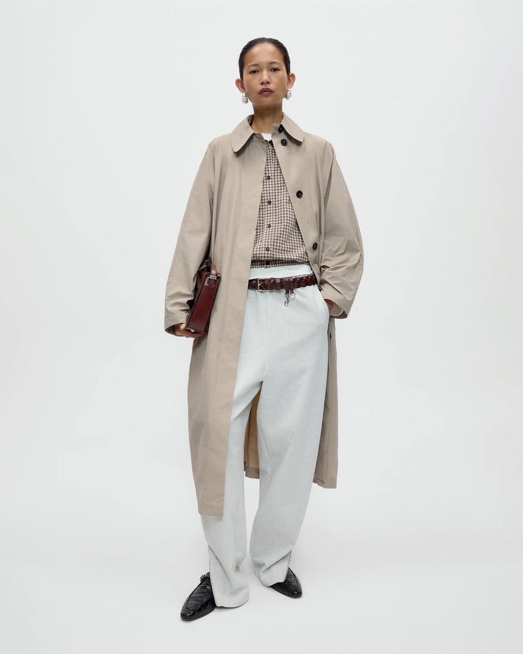 Model wearing CORDERA Lounge Pants in grey with a relaxed, straight silhouette and zippered hems.