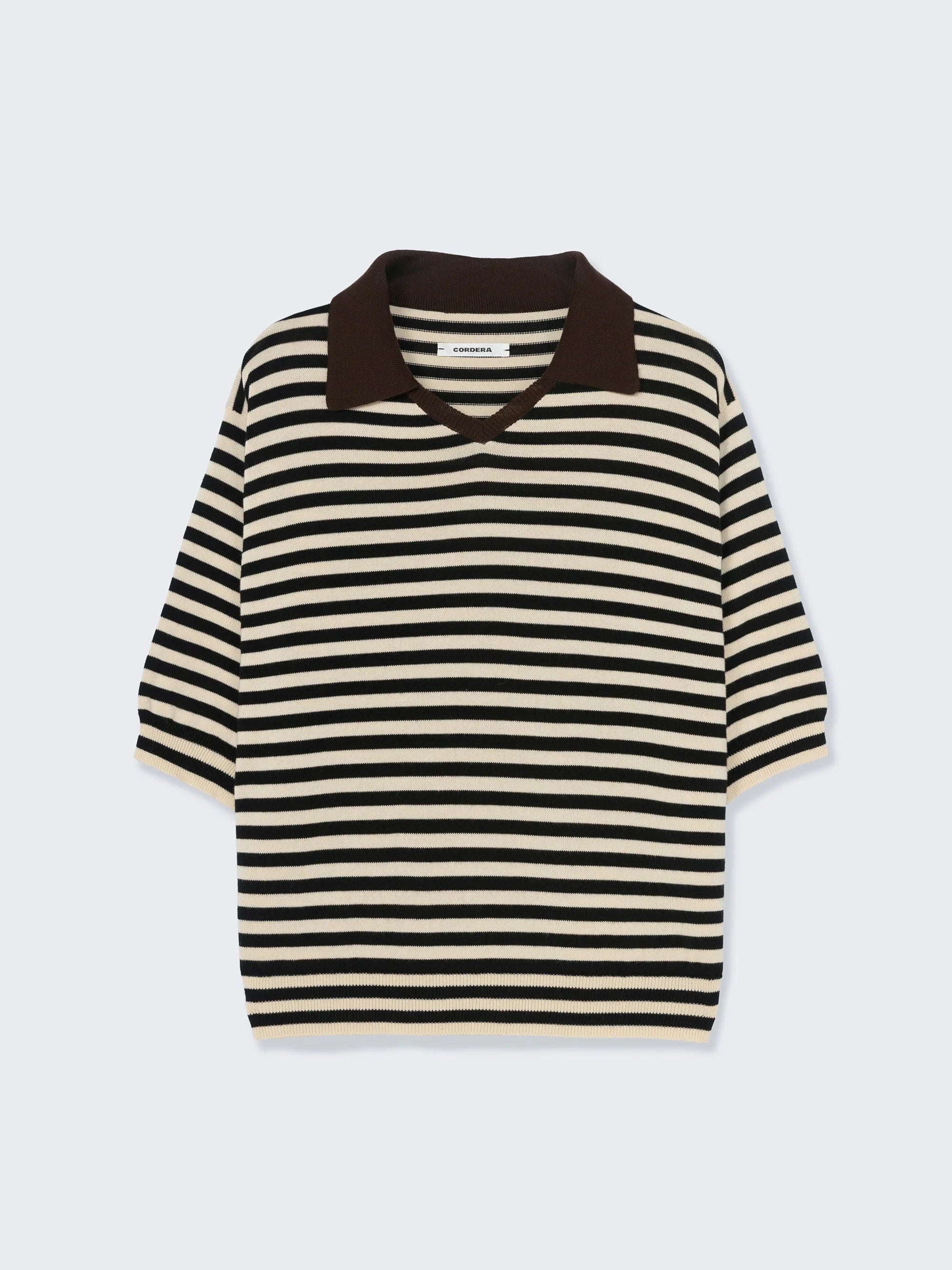 Black and white striped sweater with brown collar on a light gray background